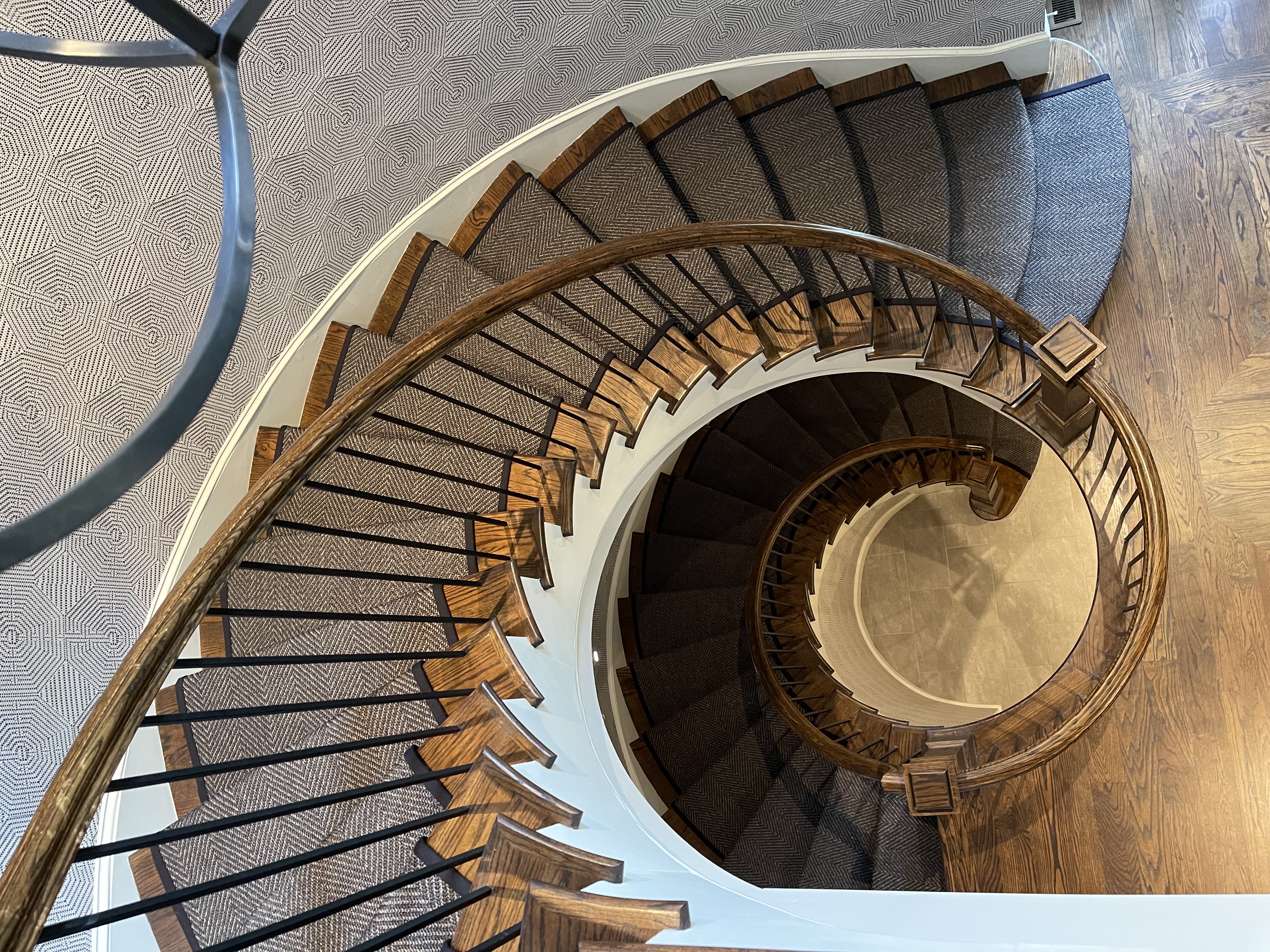 Custom stair runner installation on hardwood staircase in Atlanta home by Underfoot Design