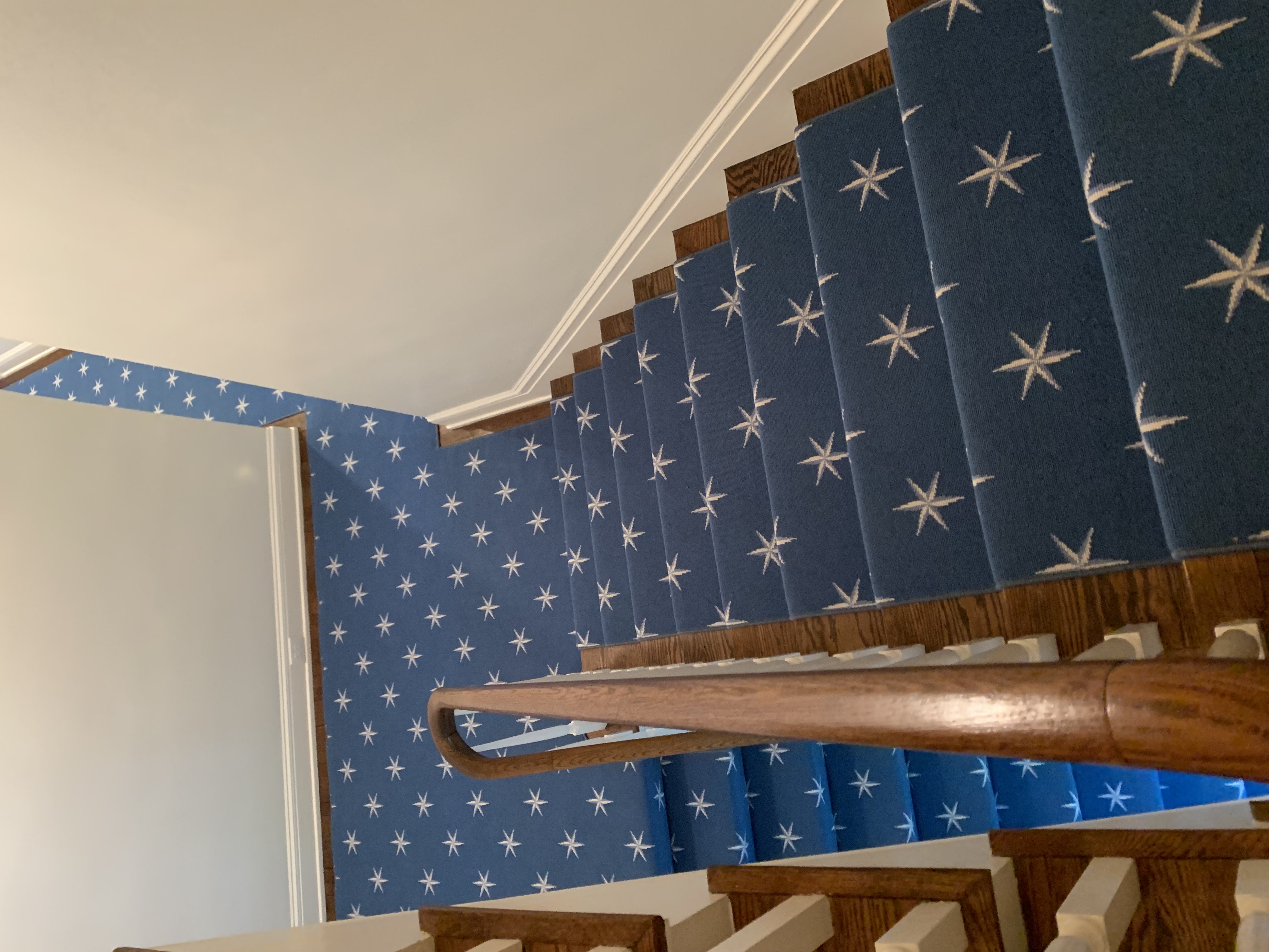 Custom navy blue star pattern logo carpet by Underfoot Design for branded space