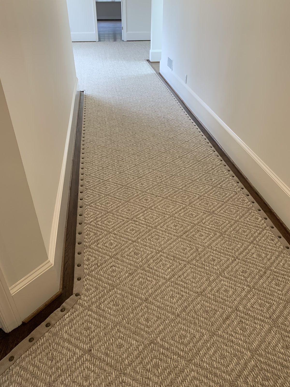 Neutral hallway runner with a bound border